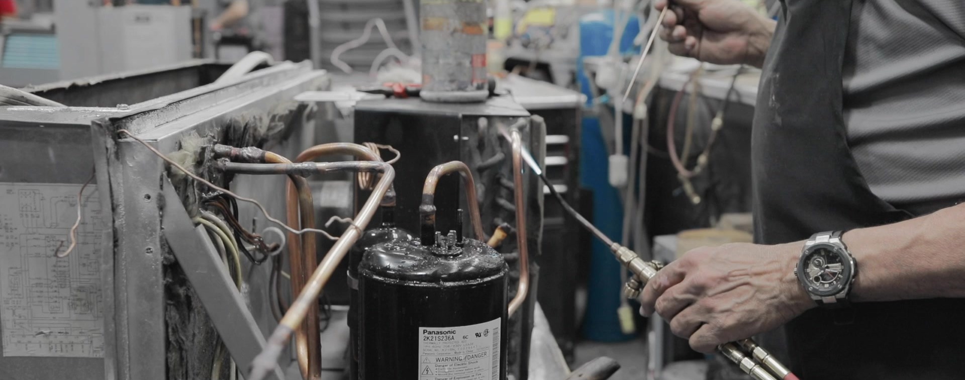 Technician brazing PTAC compressor