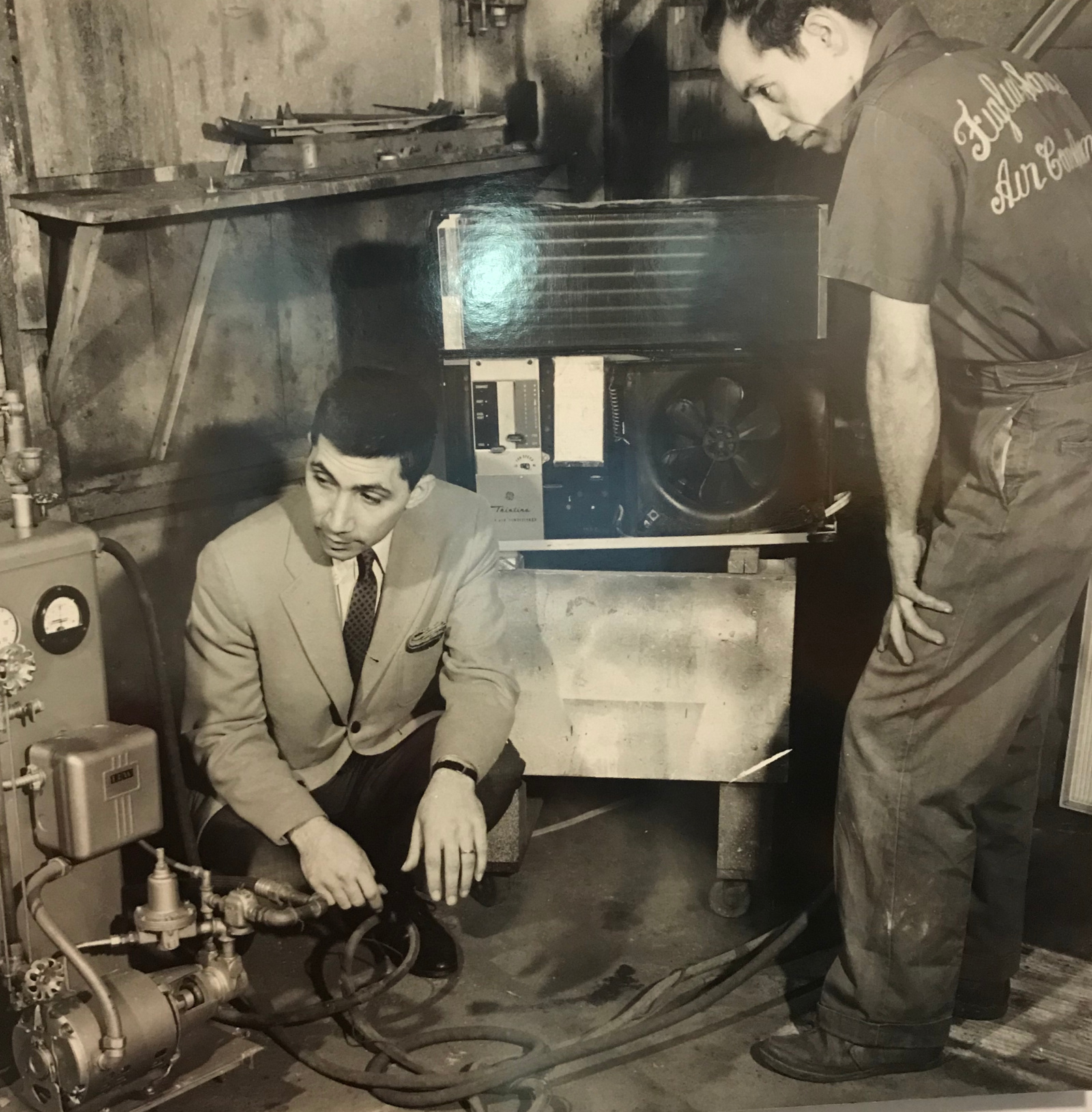 Anthony Figlia Sr. working on HVAC equipment with his team, East 9th Street, 1960s