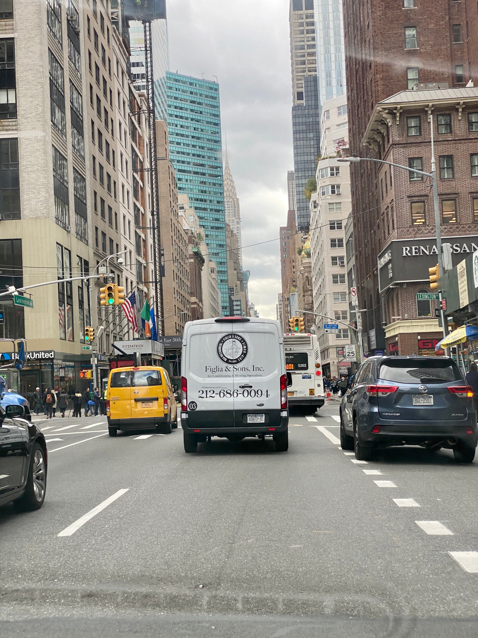 Figlia and Sons van driving through Midtown Manhattan with Chrysler Building