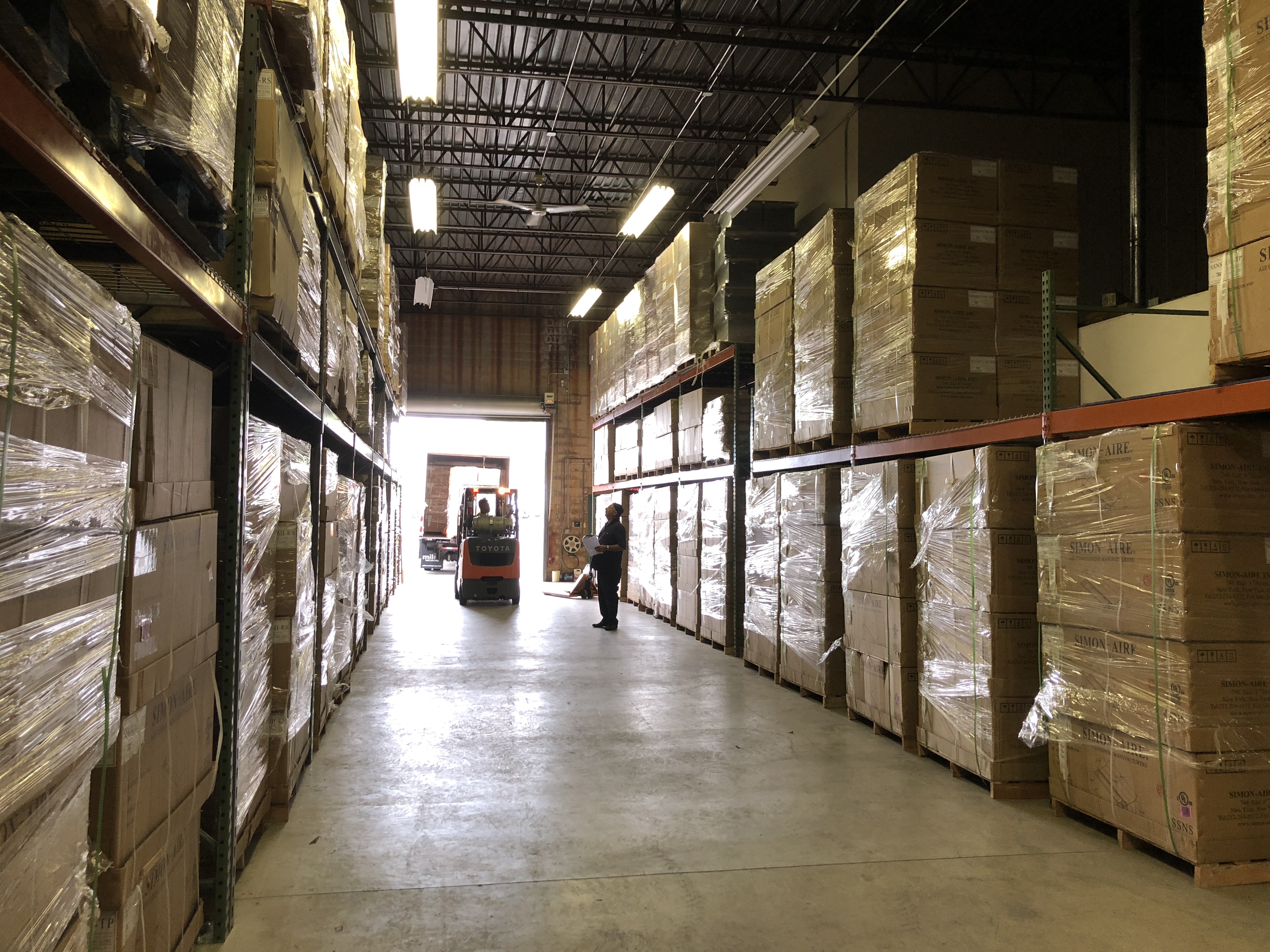 Simon-Aire warehouse stacked floor to ceiling with PTAC inventory